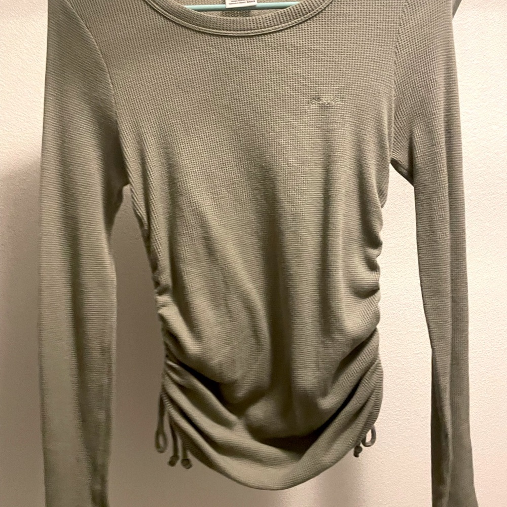 Light green shirt from PINK. Knots on side